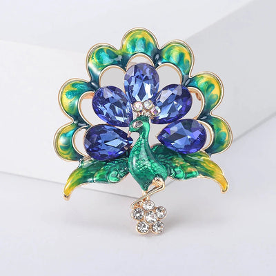 Lakshmi Crystal Peacock Brooch - A lovely stylized peacock brooch featuring glossy enamel paint and sparkling crystals.