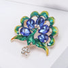 Lakshmi Crystal Peacock Brooch - A lovely stylized peacock brooch featuring glossy enamel paint and sparkling crystals.