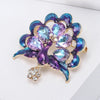 Lakshmi Crystal Peacock Brooch - A lovely stylized peacock brooch featuring glossy enamel paint and sparkling crystals.