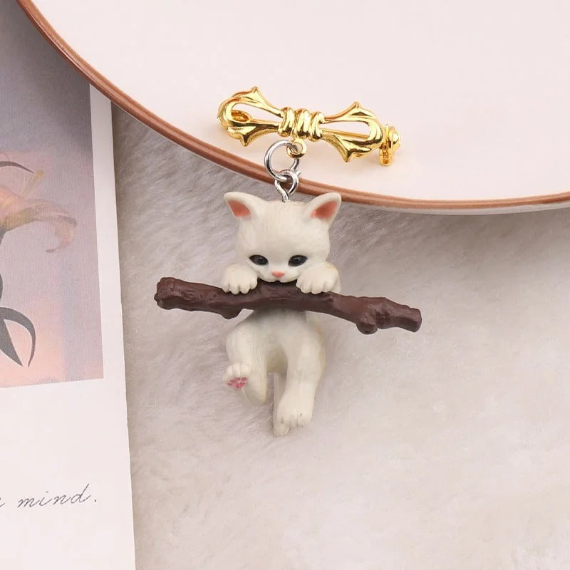 Little Adventurer Climbing Kitten Brooch - An adorable 3D sculpted resin kitten hanging from a stylised branch.