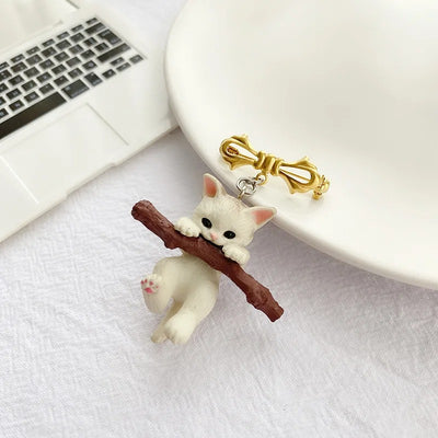 Little Adventurer Climbing Kitten Brooch - An adorable 3D sculpted resin kitten hanging from a stylised branch.