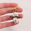 Little Adventurer Climbing Kitten Brooch - An adorable 3D sculpted resin kitten hanging from a stylised branch.