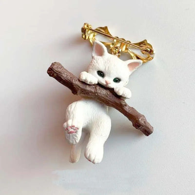 Little Adventurer Climbing Kitten Brooch - An adorable 3D sculpted resin kitten hanging from a stylised branch.