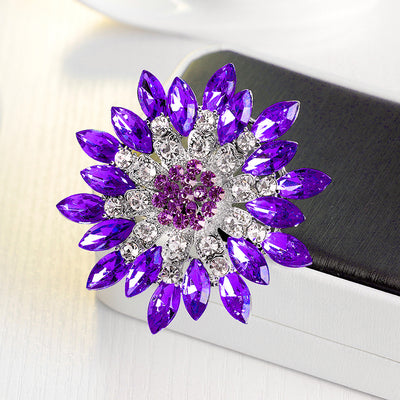 Lorrin Oversized Crystal Blossom Brooch - A large crystal blossom formed from rings of purple and white crystals arranged to form a floral pattern.