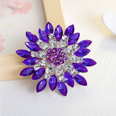 Lorrin Oversized Crystal Blossom Brooch - A large crystal blossom formed from rings of purple and white crystals arranged to form a floral pattern.