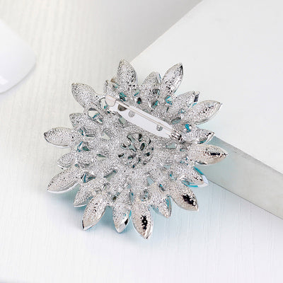 Lorrin Oversized Crystal Blossom Brooch - A large crystal blossom formed from rings of purple and white crystals arranged to form a floral pattern.