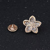 L'Petite Lapel Pins - An assortment of tiny crystal brooches in a variety of designs, including floral, foxes, birds, and geometric patterns.