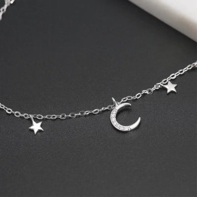 Luna Moon & Stars Charm Bracelet - A very delicate silver coloured charm bracelet decorated with moon and stars charms.