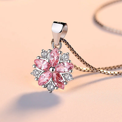 Asuka Cherry Blossom Necklace - Small, delicate crystal flower pendant on a silver box chain, with either pink or white stones.