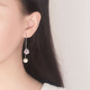 Asuka Cherry Blossom Tassel Drop Earrings - Small, delicate crystal flowers suspended from a long silver threader earring.