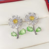 Maisey Crystal Daisy Stud Earrings - Small, delicate daisy-themed earrings, formed from a mixture of white quartz, and green and yellow topaz.