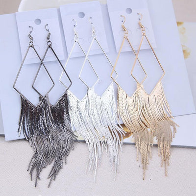 Malaika Tassel Earrings - Long stylish statement dangles, featuring a hollow diamond shape with tassels strung off it.