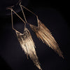 Malaika Tassel Earrings - Long stylish statement dangles, featuring a hollow diamond shape with tassels strung off it.