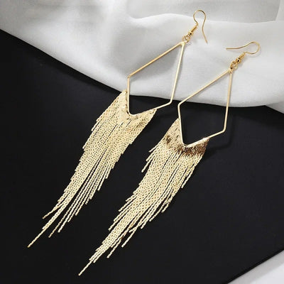 Malaika Tassel Earrings - Long stylish statement dangles, featuring a hollow diamond shape with tassels strung off it.