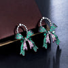 Marzanna Bowknot Statement Earrings - Large crystal-encrusted stud earrings shaped like an elegant bow, with green, pink, and white stones.