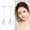 The Medusa Chain Drop Earrings - Adorable long dangling stud earrings with a crystal bow and a pearl at the end.