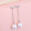 The Medusa Chain Drop Earrings - Adorable long dangling stud earrings with a crystal bow and a pearl at the end.