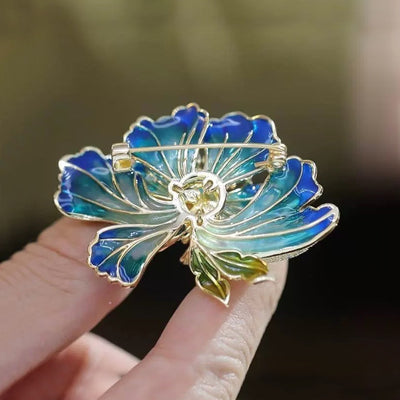 Megan Ruffled Blossom Resin Brooch - An elegant floral brooch available in blue-green, hot pink, purple, or soft pink, with shimmering crystals and semi-translucent resin.