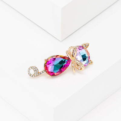 Mimmy Crystal Cat Brooch - A cute, stylised cat brooch featuring large coloured crystals for the head and body, and small round white quartz set into the ears and tail.