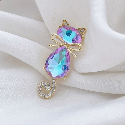 Mimmy Crystal Cat Brooch - A cute, stylised cat brooch featuring large coloured crystals for the head and body, and small round white quartz set into the ears and tail.