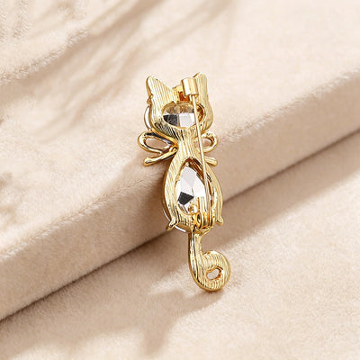 Mimmy Crystal Cat Brooch - A cute, stylised cat brooch featuring large coloured crystals for the head and body, and small round white quartz set into the ears and tail.