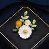 Nadine Daisy Enamel & Shell Brooch - A medium-sized, elegant floral brooch featuring two small stylised daisies, leaves, and a yellow ball.