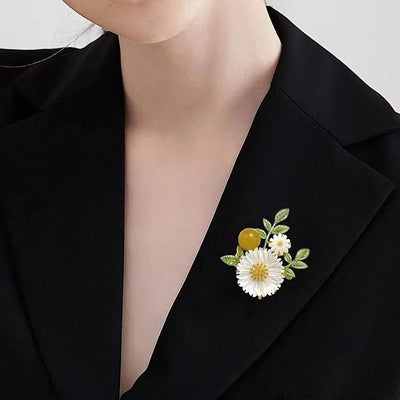 Nadine Daisy Enamel & Shell Brooch - A medium-sized, elegant floral brooch featuring two small stylised daisies, leaves, and a yellow ball.