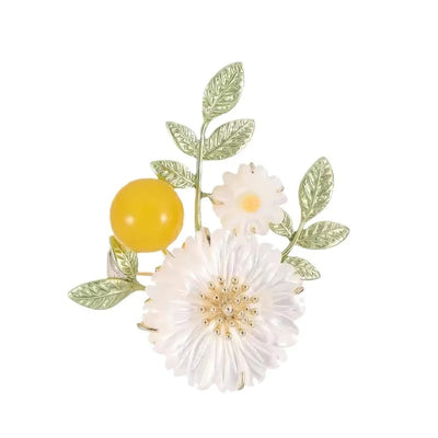 Nadine Daisy Enamel & Shell Brooch - A medium-sized, elegant floral brooch featuring two small stylised daisies, leaves, and a yellow ball.