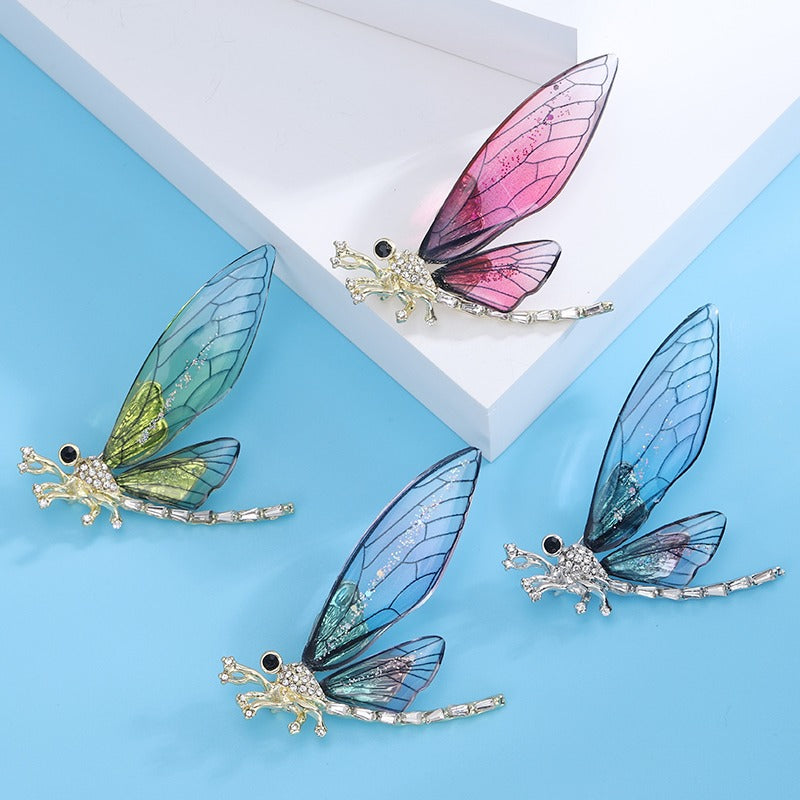 Nevaeh Dragonfly Brooch - A large, stylized dragonfly brooch with colourful epoxy resin wings, available in blue, green, or red.
