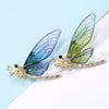Nevaeh Dragonfly Brooch - A large, stylized dragonfly brooch with colourful epoxy resin wings, available in blue, green, or red.