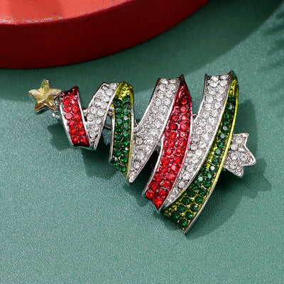 Noelle Christmas Tree Crystal Brooch - A lovely, sparkly crystal brooch shaped like a classic Christmas tree, adorned with red, green, and white stones and a golden star on top.