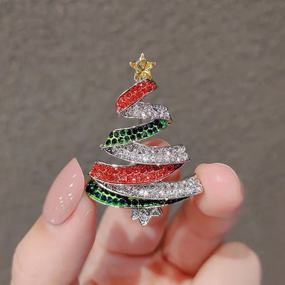 Noelle Christmas Tree Crystal Brooch - A lovely, sparkly crystal brooch shaped like a classic Christmas tree, adorned with red, green, and white stones and a golden star on top.