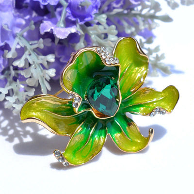 The Odessa Enamel Orchid Brooch - A lovely flower-themed brooch featuring six wavy petals around a large teardrop-shaped central stone.