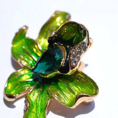 The Odessa Enamel Orchid Brooch - A lovely flower-themed brooch featuring six wavy petals around a large teardrop-shaped central stone.