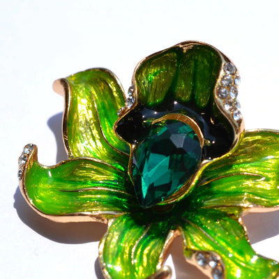The Odessa Enamel Orchid Brooch - A lovely flower-themed brooch featuring six wavy petals around a large teardrop-shaped central stone.