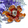The Odessa Enamel Orchid Brooch - A lovely flower-themed brooch featuring six wavy petals around a large teardrop-shaped central stone.