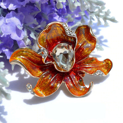 The Odessa Enamel Orchid Brooch - A lovely flower-themed brooch featuring six wavy petals around a large teardrop-shaped central stone.