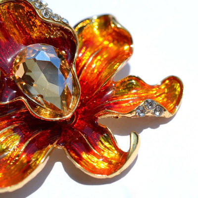 The Odessa Enamel Orchid Brooch - A lovely flower-themed brooch featuring six wavy petals around a large teardrop-shaped central stone.
