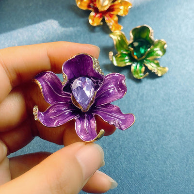The Odessa Enamel Orchid Brooch - A lovely flower-themed brooch featuring six wavy petals around a large teardrop-shaped central stone.