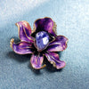 The Odessa Enamel Orchid Brooch - A lovely flower-themed brooch featuring six wavy petals around a large teardrop-shaped central stone.