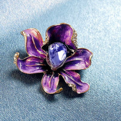 The Odessa Enamel Orchid Brooch - A lovely flower-themed brooch featuring six wavy petals around a large teardrop-shaped central stone.