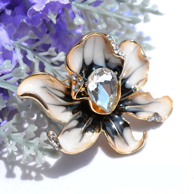 The Odessa Enamel Orchid Brooch - A lovely flower-themed brooch featuring six wavy petals around a large teardrop-shaped central stone.