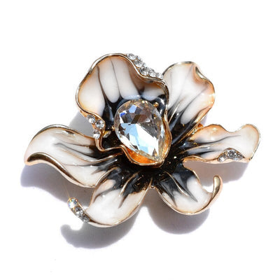 The Odessa Enamel Orchid Brooch - A lovely flower-themed brooch featuring six wavy petals around a large teardrop-shaped central stone.