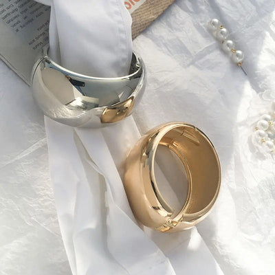 Ovalyn Hinged Cuff Bangle - A simple round gold bangle with a mirrored finish, available in champagne or white gold.