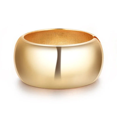 Ovalyn Hinged Cuff Bangle - A simple round gold bangle with a mirrored finish, available in champagne or white gold.