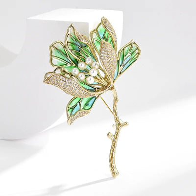 The Helena Hibiscus Sculpted Resin Brooch is a lovely, long, elegant piece that features seven ruffled petals clustered around a sprig of pearl stamen, with colourful resin to really make it pop and a dusting of crystal along the underside of the petals.