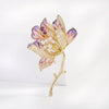 The Helena Hibiscus Sculpted Resin Brooch is a lovely, long, elegant piece that features seven ruffled petals clustered around a sprig of pearl stamen, with colourful resin to really make it pop and a dusting of crystal along the underside of the petals.