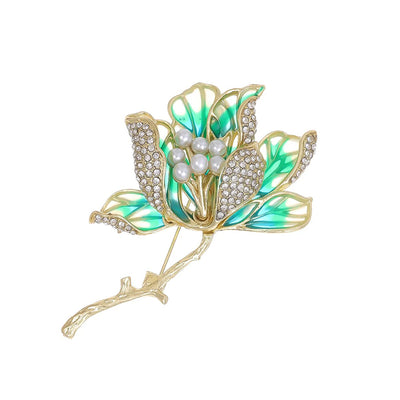 The Helena Hibiscus Sculpted Resin Brooch is a lovely, long, elegant piece that features seven ruffled petals clustered around a sprig of pearl stamen, with colourful resin to really make it pop and a dusting of crystal along the underside of the petals.