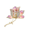 The Helena Hibiscus Sculpted Resin Brooch is a lovely, long, elegant piece that features seven ruffled petals clustered around a sprig of pearl stamen, with colourful resin to really make it pop and a dusting of crystal along the underside of the petals.