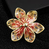 Isabelle Iris Sculpted Resin Brooch - An elegant floral brooch available in green, purple, or salmon pink, with shimmering crystals and semi-translucent resin.